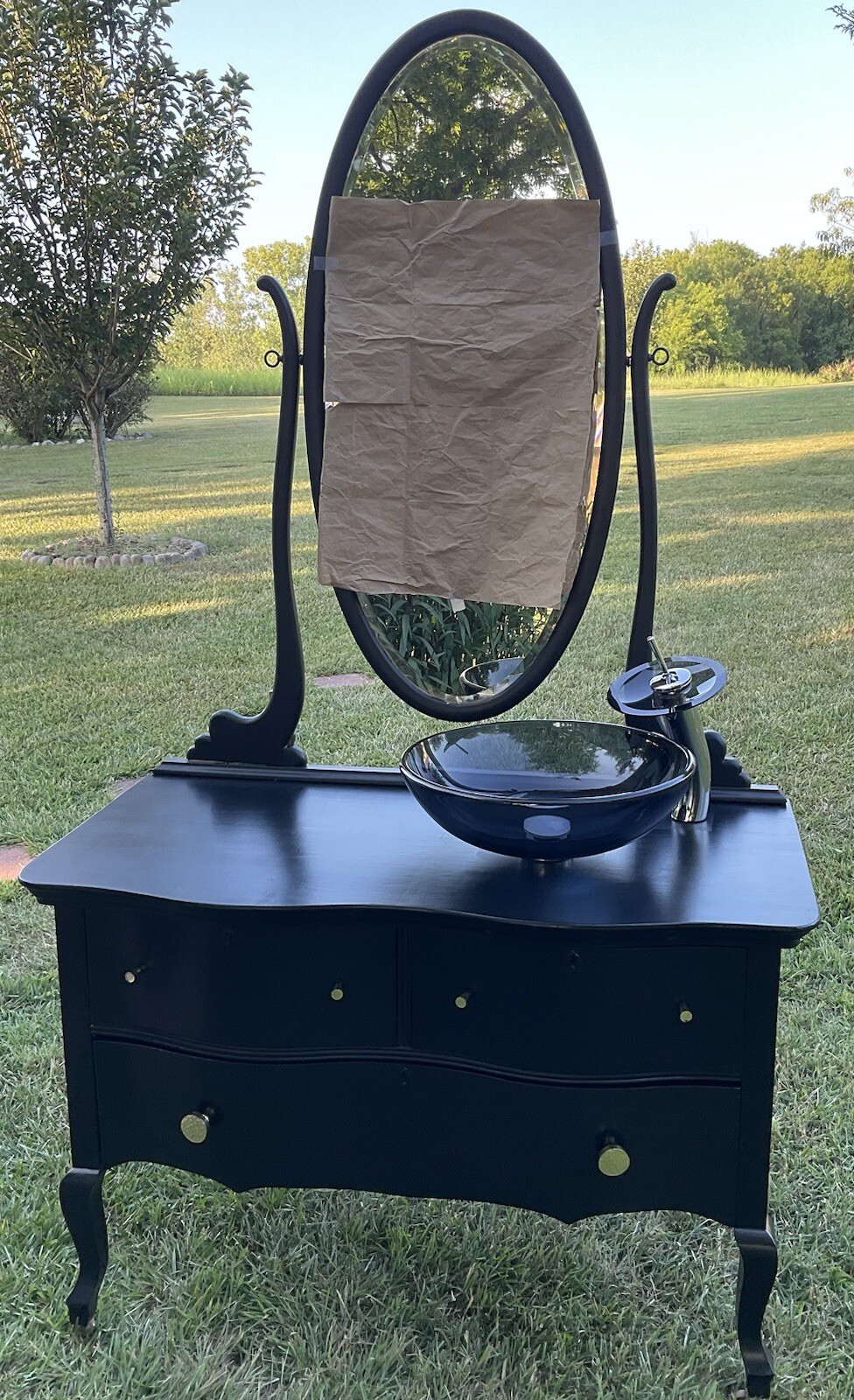 Antique Princess Dresser converted to bathroom vanity with black sink and faucet